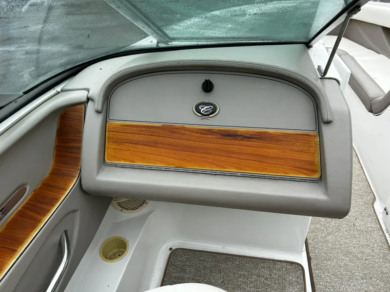 Slide: The Image of 2001 Cobalt 226 boat dashboard with wood accents and storage compartment. - 22