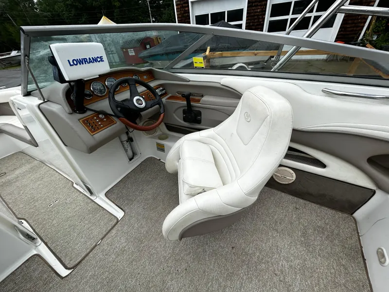 Slide: The Image of 2001 Cobalt 226 boat interior with white captain's chair and Lowrance navigation system. - 24
