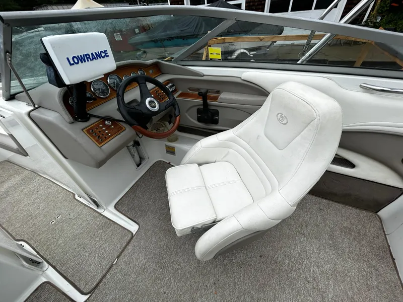 Slide: The Image of 2001 Cobalt 226 boat cockpit with Lowrance navigation system and white captain's chair. - 25