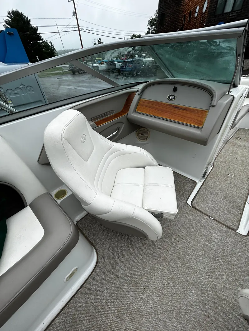 Slide: The Image of 2001 Cobalt 226 boat interior with white seating and dashboard. - 26