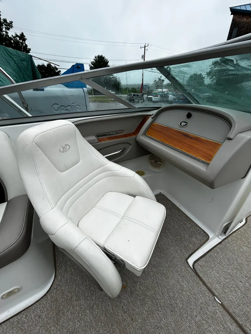 Slide: The Image of 2001 Cobalt 226 boat interior with white seating and wood accents. - 27