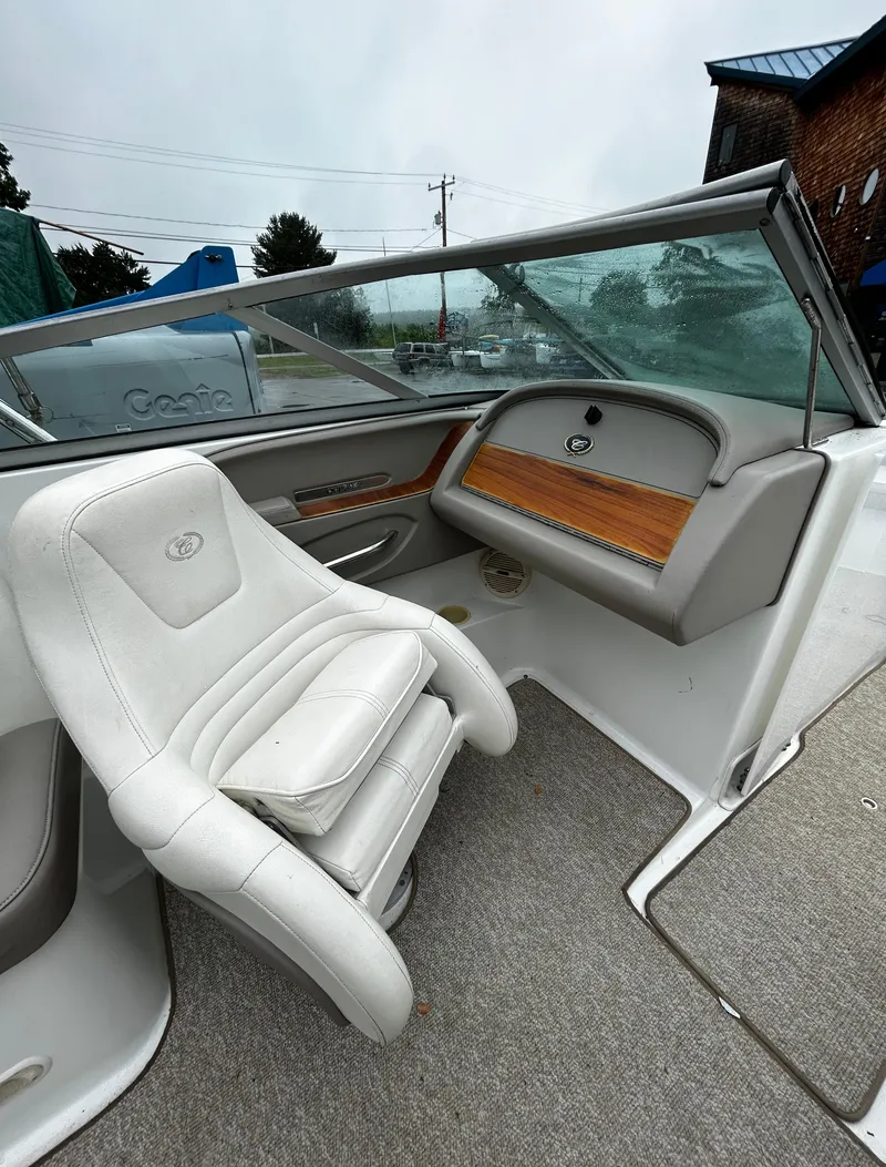 Slide: The Image of 2001 Cobalt 226 boat interior with white captain's chair and dashboard. - 28