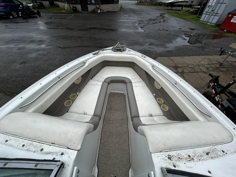 Slide: The Image of 2001 Cobalt 226 boat bow seating area with white and gray upholstery. - 31