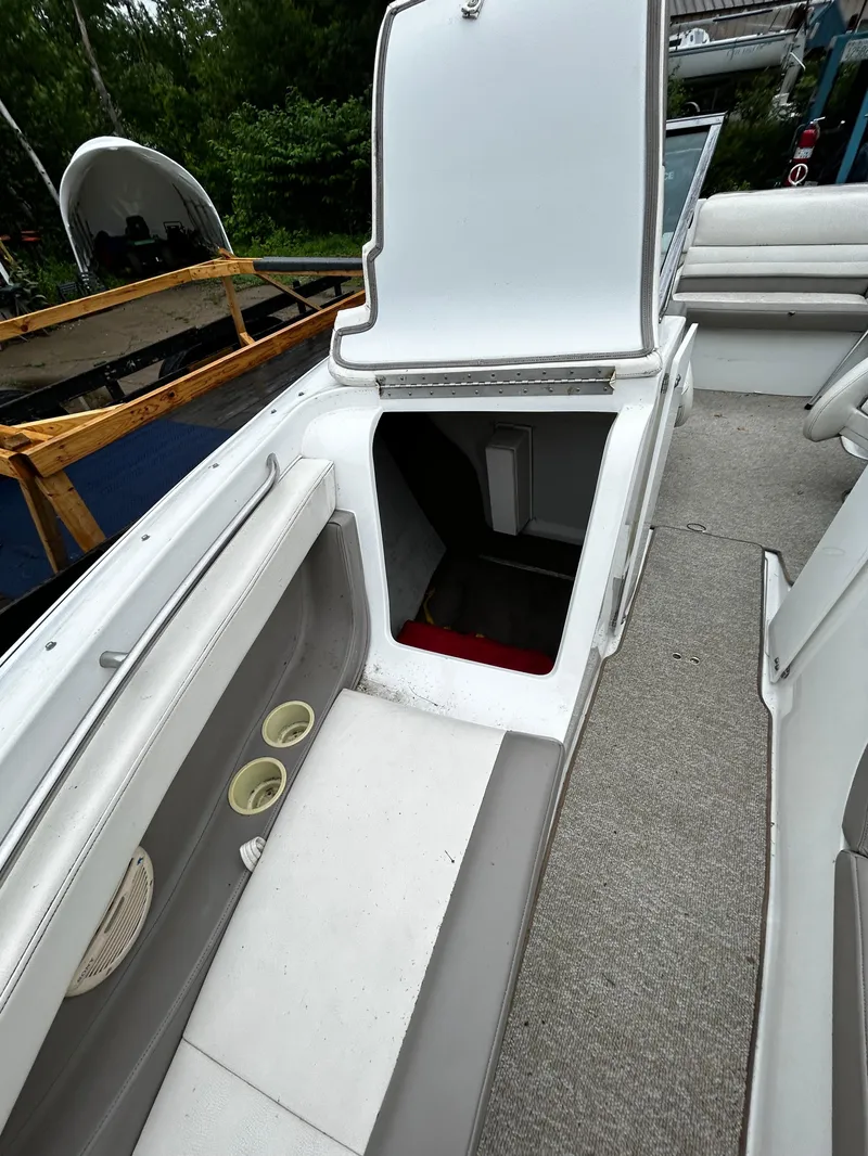 Slide: The Image of 2001 Cobalt 226 boat interior with open storage compartment. - 36