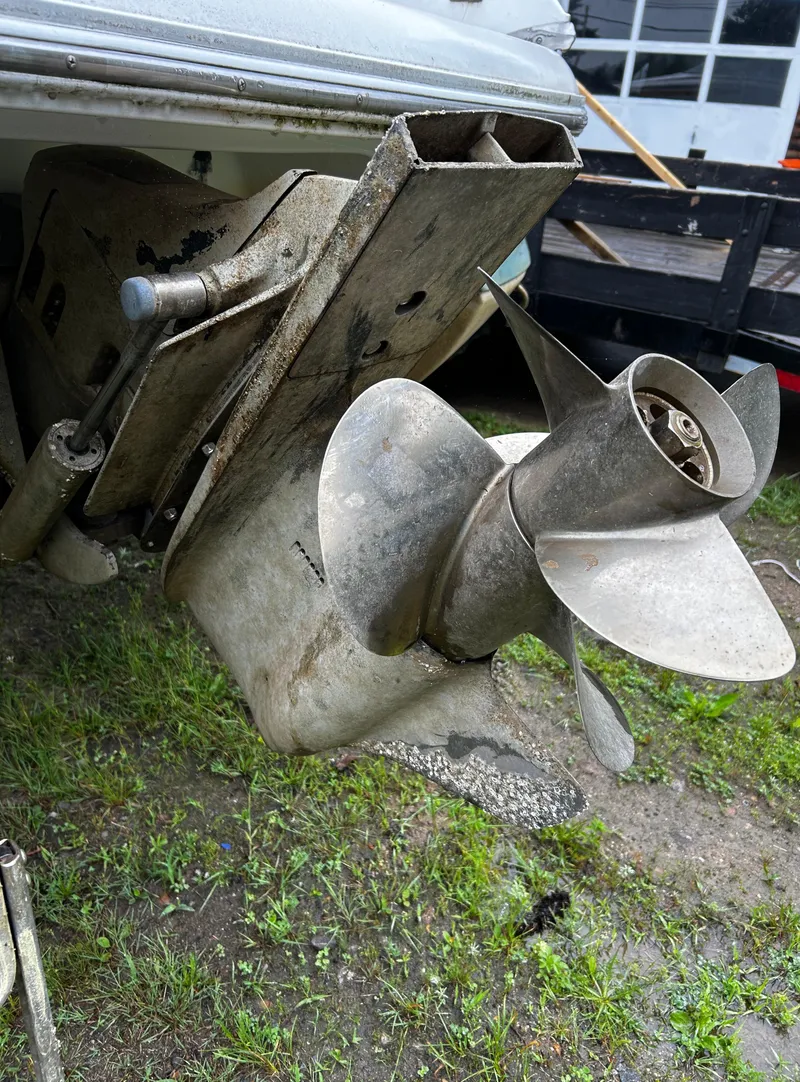 Slide: The Image of 2001 Cobalt 226 boat propeller and stern drive in a yard. - 39