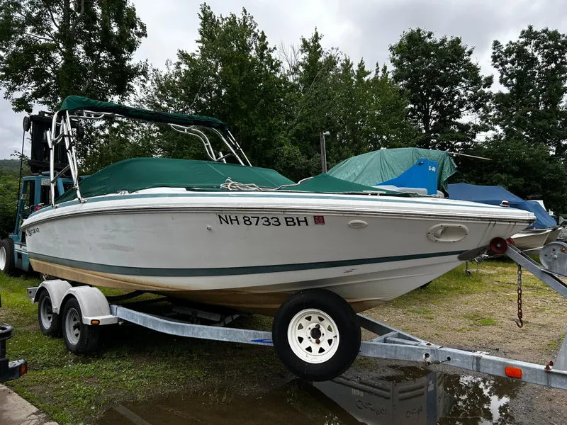Slide: The Image of 2001 Cobalt 226 boat on trailer with green cover in outdoor storage. - 7