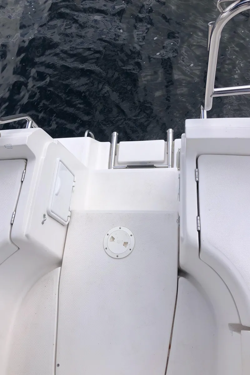 Slide: The Image of 2004 Hunter 33 boat deck with ladder, overlooking water. - 14