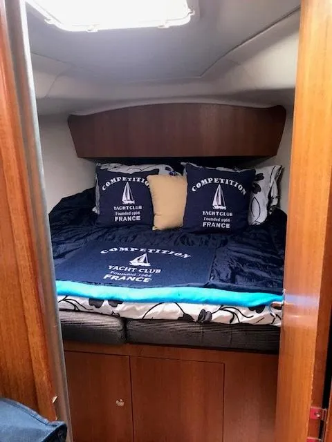Slide: The Image of Cozy cabin interior of 2004 Hunter 33 yacht with nautical-themed bedding. - 16