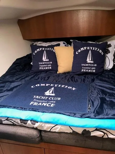 Slide: The Image of Cozy cabin interior of 2004 Hunter 33 yacht with nautical-themed bedding. - 17