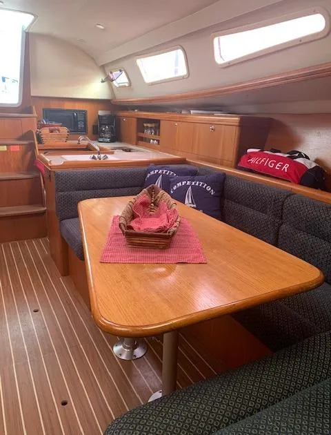 Slide: The Image of Interior of 2004 Hunter 33 sailboat with cozy dining area and wooden finishes. - 23