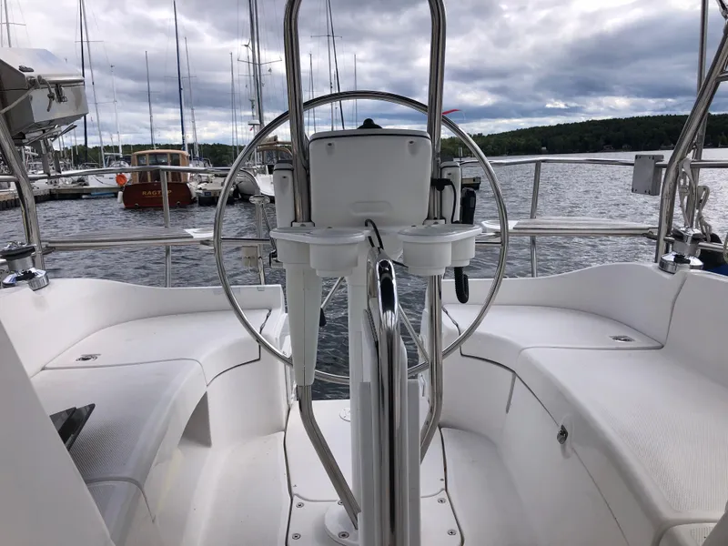 Slide: The Image of Cockpit of a 2004 Hunter 33 sailboat with steering wheel, docked at marina. - 5