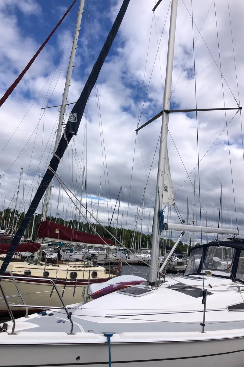 Slide: The Image of Sailboat Hunter 33, 2004 model, docked at marina under cloudy sky. - 6