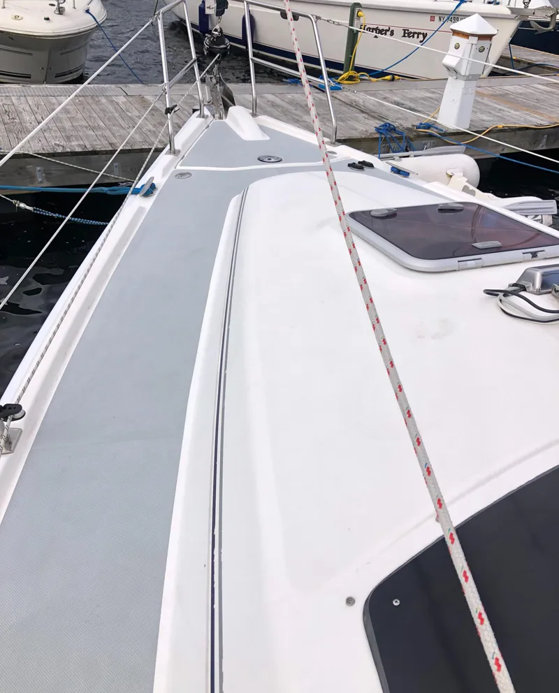 Slide: The Image of 2004 Hunter 33 sailboat deck view at marina, showcasing sleek design and rigging. - 9