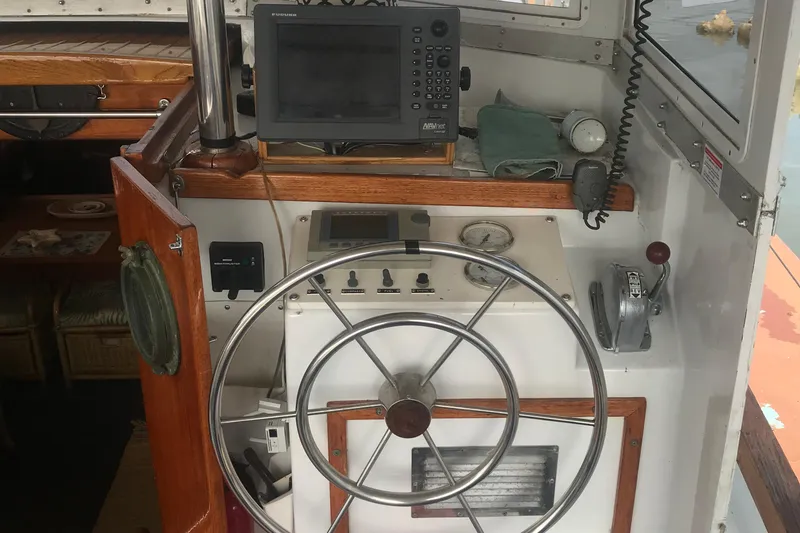 Slide: The Image of Cockpit of 1984 Custom 43 Steady Sailor with steering wheel and navigation equipment. - 11