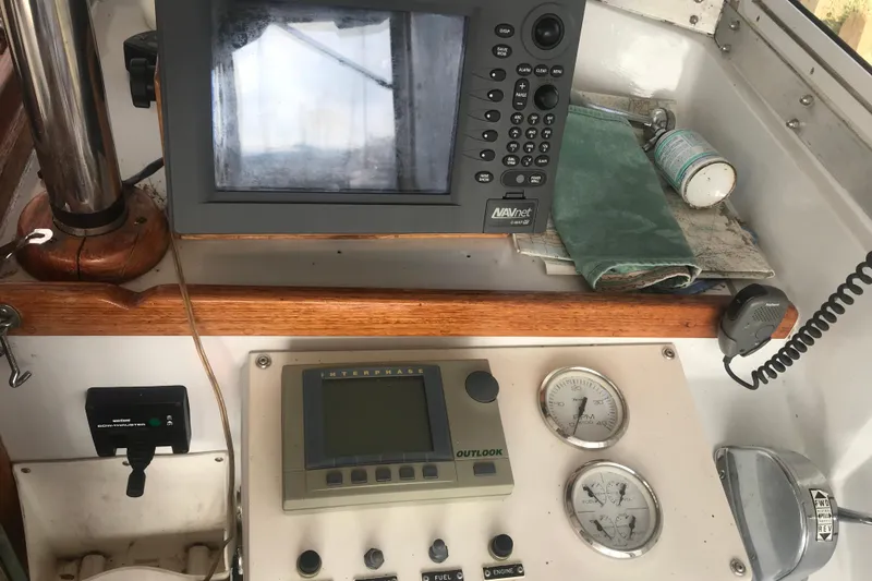 Slide: The Image of Cockpit instruments of a 1984 Custom 43 Steady Sailor, featuring navigation and control panels. - 13