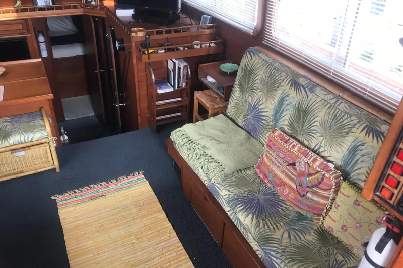 Slide: The Image of Interior of 1984 Custom 43 Steady Sailor with tropical decor and cozy seating area. - 14