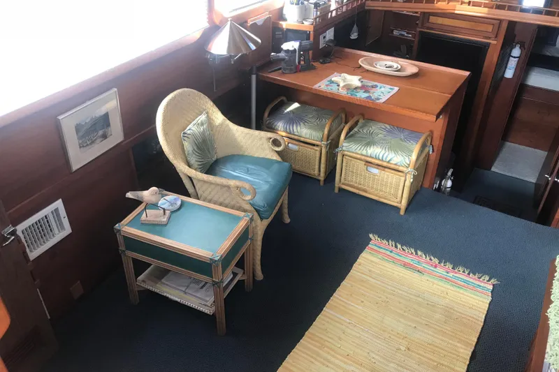 Slide: The Image of Cozy interior of 1984 Custom 43 Steady Sailor with wicker furniture and nautical decor. - 15
