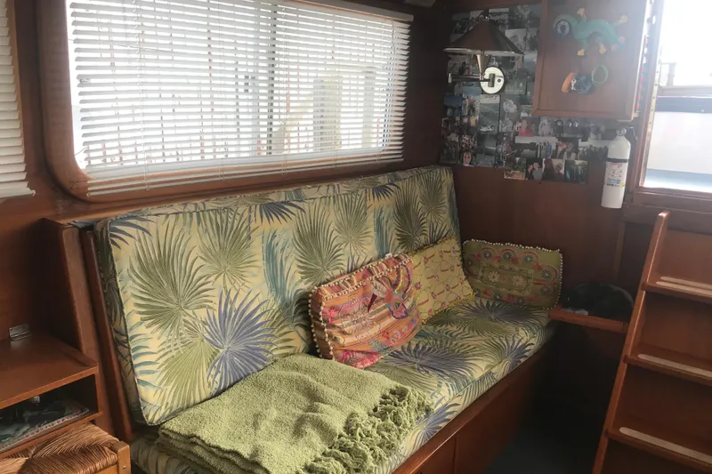 Slide: The Image of Cozy interior of 1984 Custom 43 Steady Sailor with tropical cushions and decorative pillows. - 17