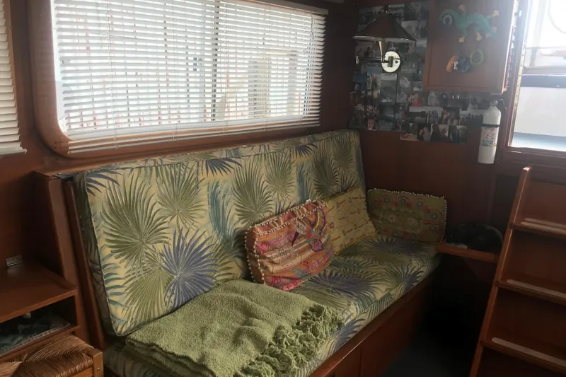 Slide: The Image of Cozy interior of 1984 Custom 43 Steady Sailor with tropical-patterned sofa and decorative pillows. - 19