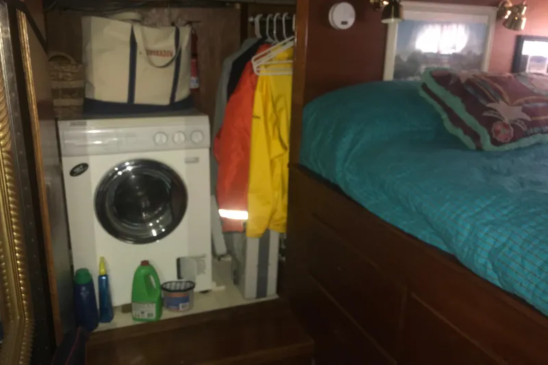Slide: The Image of Laundry area and bed inside a 1984 Custom 43 Steady Sailor boat cabin. - 22