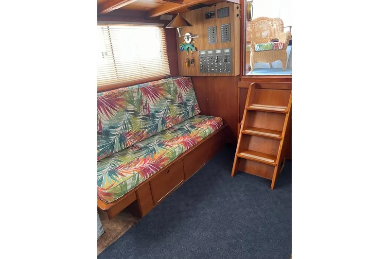 Slide: The Image of Interior of 1984 Custom 43 Steady Sailor with tropical upholstery and wooden ladder. - 26