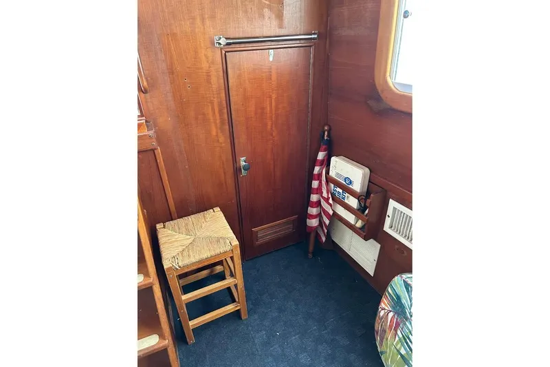 Slide: The Image of Interior of 1984 Custom 43 Steady Sailor with wooden paneling and nautical decor. - 29