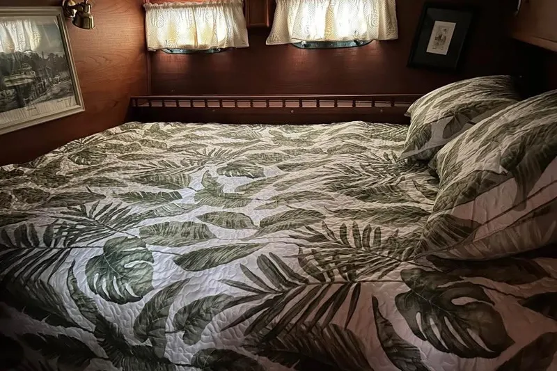 Slide: The Image of Cozy cabin bedroom in 1984 Custom 43 Steady Sailor with tropical leaf bedding. - 38