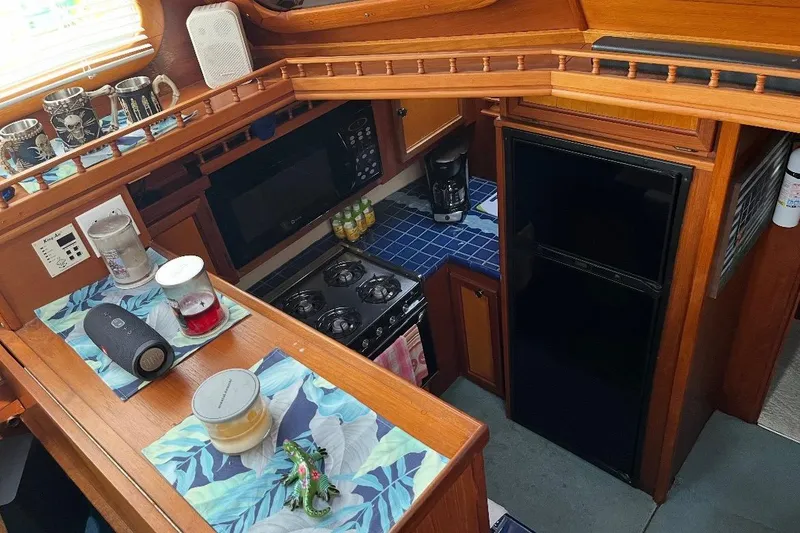 Slide: The Image of Interior of 1984 Custom 43 Steady Sailor yacht kitchen with wooden cabinetry. - 4