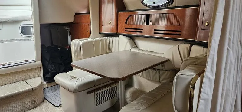 Slide: The Image of 2001 Sea Ray Sundancer 280 cabin interior with dining area and seating. - 10