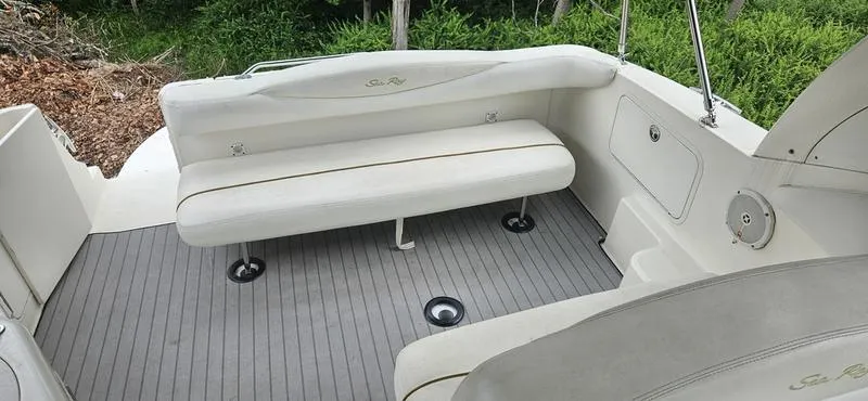 Slide: The Image of 2001 Sea Ray Sundancer 280 boat interior with white seating and gray flooring. - 11