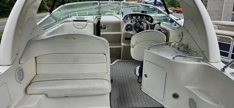 Slide: The Image of 2001 Sea Ray Sundancer 280 boat interior with helm and seating area. - 12