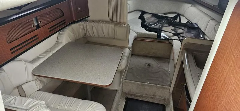 Slide: The Image of 2001 Sea Ray Sundancer 280 cabin interior with dining area and seating. - 9