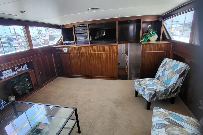 Slide: The Image of 1970 Chris-Craft Commander interior with wood paneling, modern seating, and entertainment center. - 11