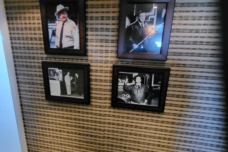 Slide: The Image of Four framed black-and-white photos on a patterned wall, featuring various individuals. - 19