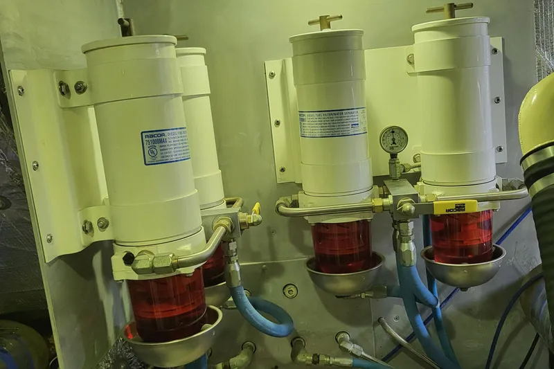 Slide: The Image of Engine room filters on a 1970 Chris-Craft Commander boat, featuring red and white components. - 24