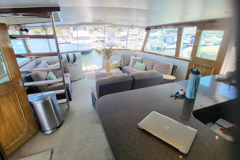Slide: The Image of 1970 Chris-Craft Commander yacht interior with modern seating and marina view. - 6