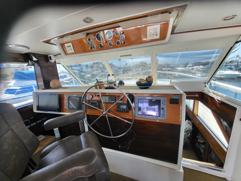 Slide: The Image of 1970 Chris-Craft Commander boat helm with steering wheel, gauges, and navigation equipment. - 8
