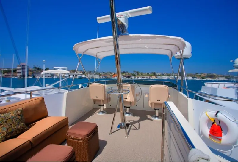 Slide: The Image of 1970 Chris-Craft Commander yacht deck with seating, helm, and ocean view. - 9