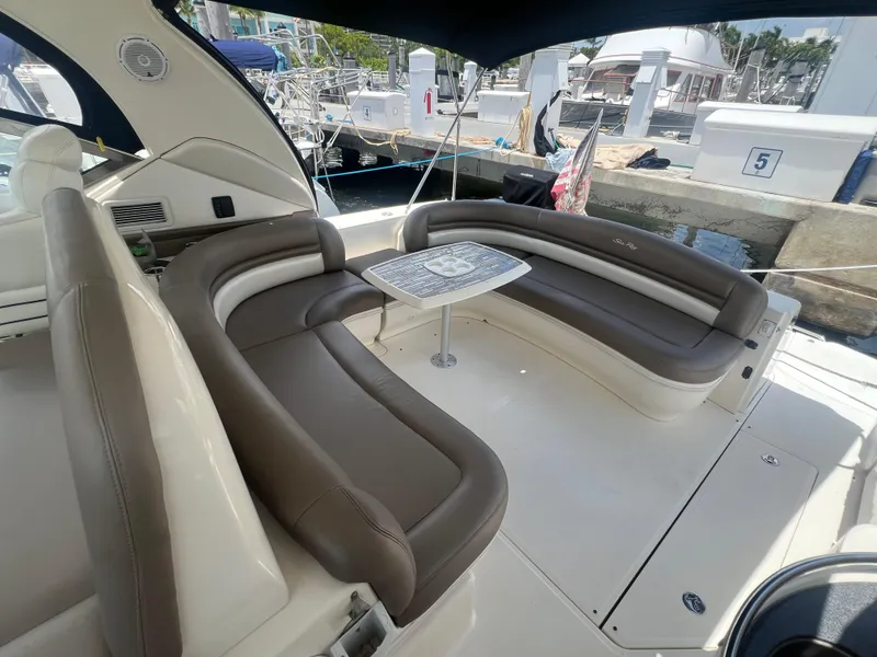 Slide: The Image of 2005 Sea Ray 420 Sundancer yacht with spacious seating and table in the cockpit area. - 11