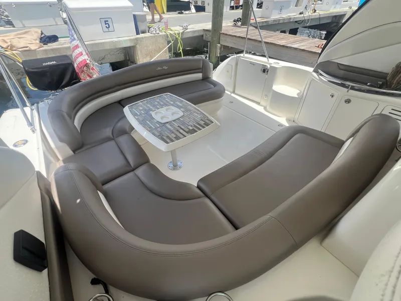Slide: The Image of 2005 Sea Ray 420 Sundancer yacht with spacious seating and table in the cockpit area. - 12