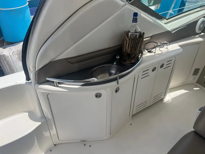Slide: The Image of 2005 Sea Ray 420 Sundancer yacht interior with sink and storage cabinets. - 13