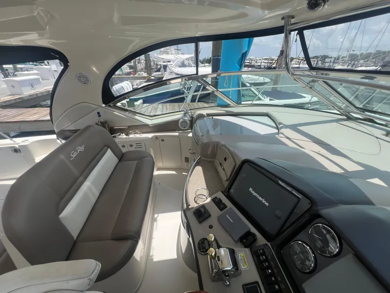 Slide: The Image of Interior of 2005 Sea Ray 420 Sundancer yacht with modern dashboard and seating. - 16