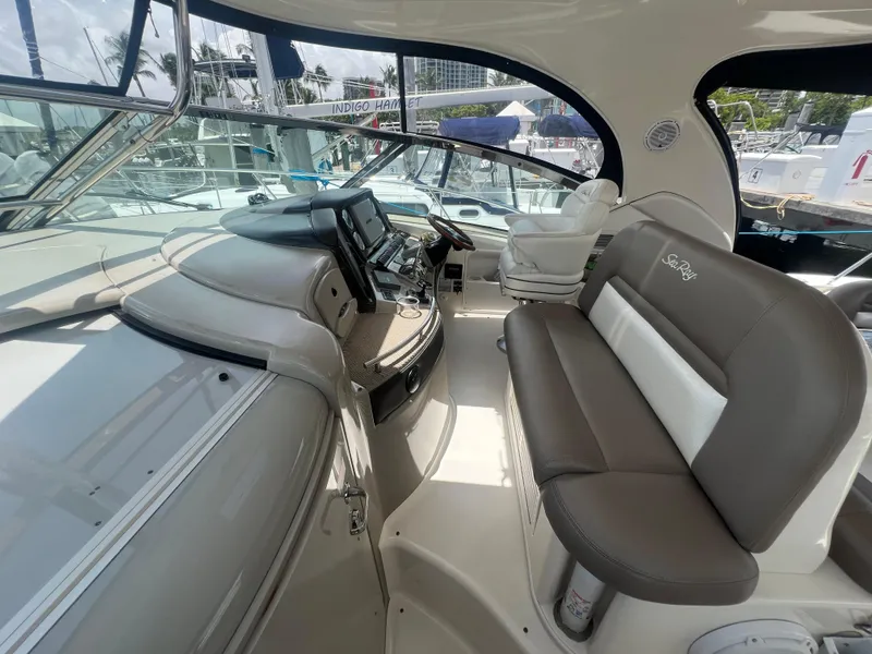Slide: The Image of 2005 Sea Ray 420 Sundancer cockpit with modern controls and comfortable seating. - 17