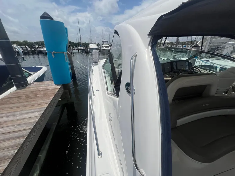 Slide: The Image of 2005 Sea Ray 420 Sundancer docked at marina under clear skies. - 20