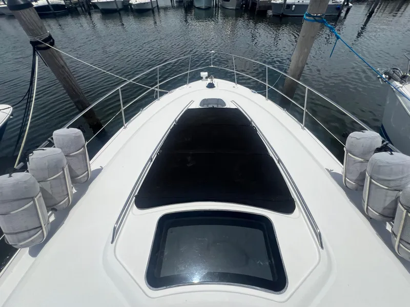 Slide: The Image of 2005 Sea Ray 420 Sundancer yacht bow view at marina. - 23