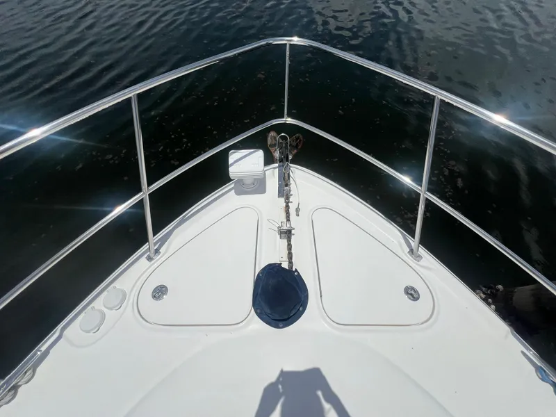Slide: The Image of Bow of 2005 Sea Ray 420 Sundancer yacht on calm water. - 24