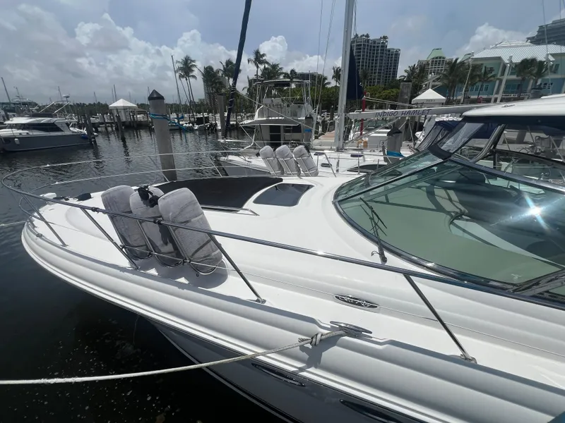 Slide: The Image of 2005 Sea Ray 420 Sundancer yacht docked at marina under cloudy sky. - 3