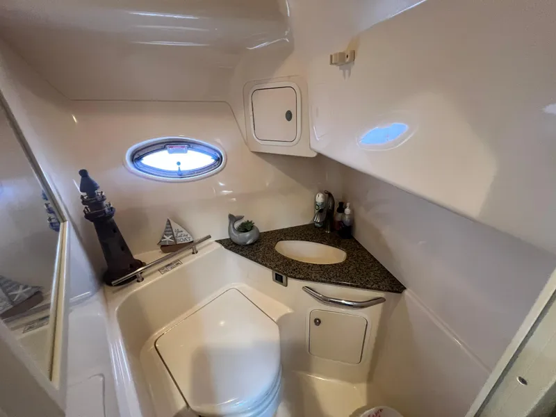 Slide: The Image of Luxurious bathroom in 2005 Sea Ray 420 Sundancer yacht with modern fixtures and porthole window. - 34