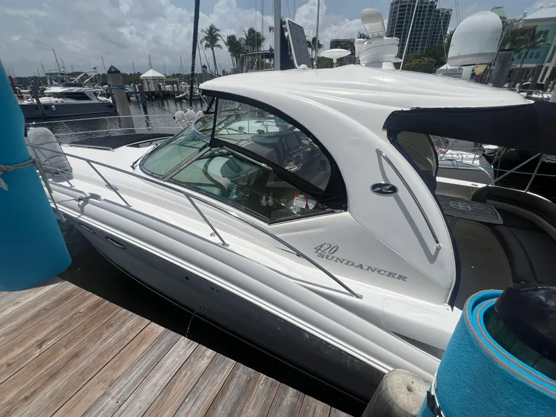 Slide: The Image of 2005 Sea Ray 420 Sundancer docked at marina, side view. - 4