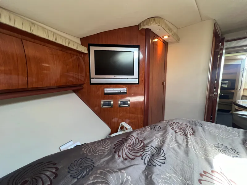 Slide: The Image of Luxurious 2005 Sea Ray 420 Sundancer cabin with TV and elegant wood paneling. - 42